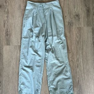 Lightweight Womens sea foam green pants with pleated front, tie, side pockets.